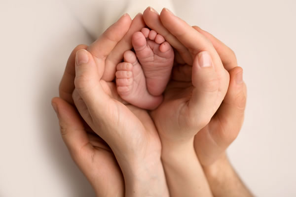 Baby Feet in Parents' Hands